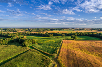 an-aerial-drone-photo-over-the-fields-and-dirt-road-lanes-in-the-fields-during-the-golden-light-of-the-morning-stockpack-istock.jpg