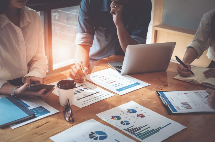 businessman-holding-pens-and-holding-graph-paper-are-meeting-to-plan-sales-to-meet-targets-set-in-next-year-audit-budget-and-financial-concept-stockpack-istock.jpg