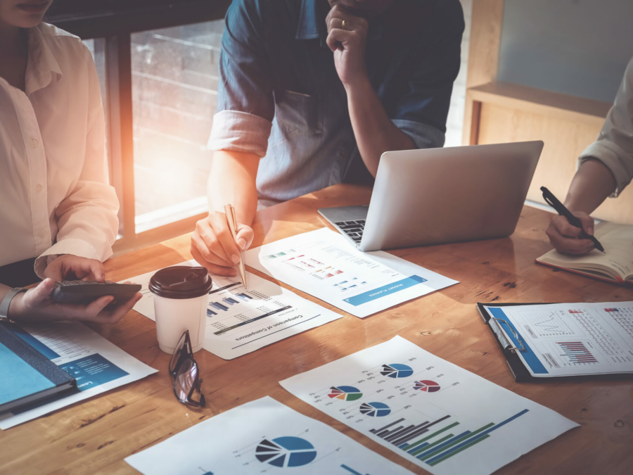 businessman-holding-pens-and-holding-graph-paper-are-meeting-to-plan-sales-to-meet-targets-set-in-next-year-audit-budget-and-financial-concept-stockpack-istock.jpg