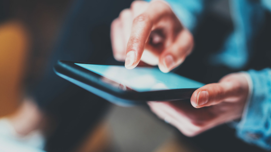 closeup-view-of-woman-holding-modern-smartphone-in-handsgirl-typing-on-white-touch-mobile-screen-horizontal-blurred-background-bokeh-effectsmacro-stockpack-istock.jpg