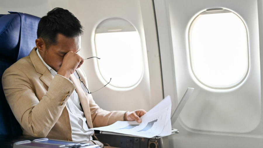 tired-overworked-and-stressed-asian-businessman-reviewing-financial-report-working-and-managing-his-tasks-during-the-flight-stockpack-istock.jpg