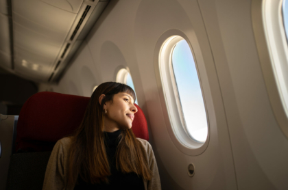 young-woman-traveling-by-plane-looking-out-the-window-stockpack-istock.jpg