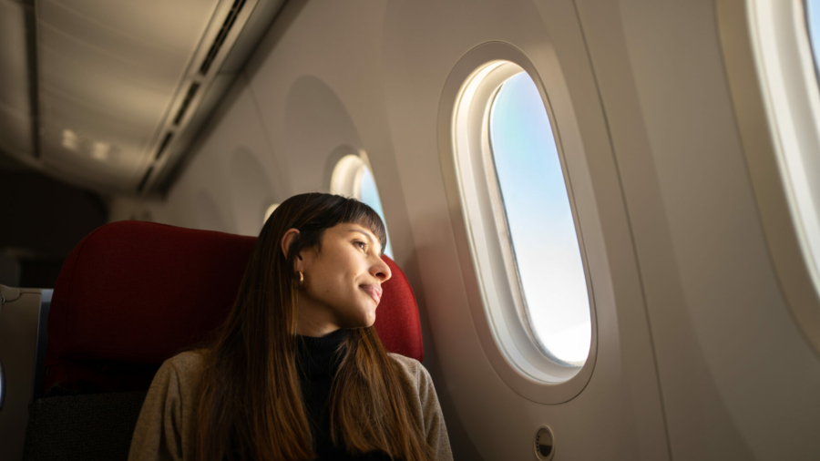 young-woman-traveling-by-plane-looking-out-the-window-stockpack-istock.jpg